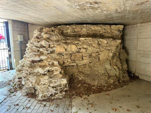 a stone wall in a room with a building at Casa sulle mura Romane - Old town in Bergamo