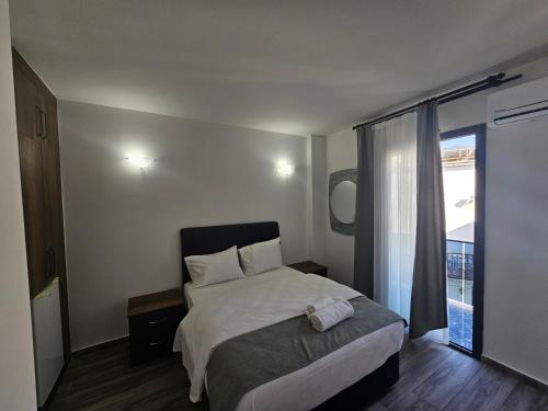 a bedroom with a bed and a large window at Cyprus Harbour Suites in Kyrenia