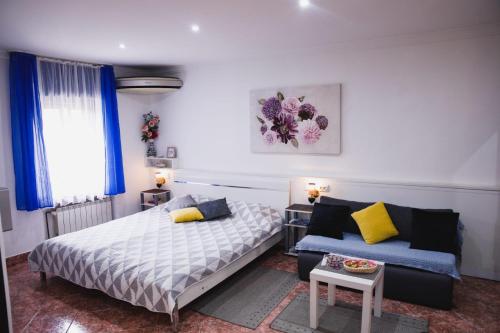 a bedroom with a bed and a couch at Apartments Dajčić in Varaždinske Toplice