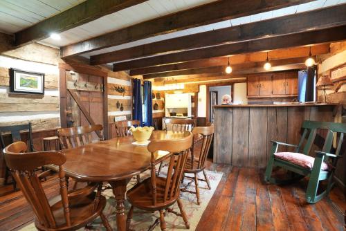 a dining room with a wooden table and chairs at Extended Stays by Lee House Inn in Maysville
