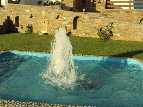 a water fountain in the middle of a yard at Villa Helen in ayios Petros