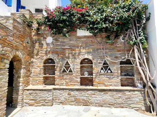 a building with flowers on the side of it at Villa Helen in ayios Petros