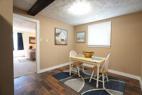 a dining room with a table and two chairs at Extended Stays by Lee House Inn in Maysville