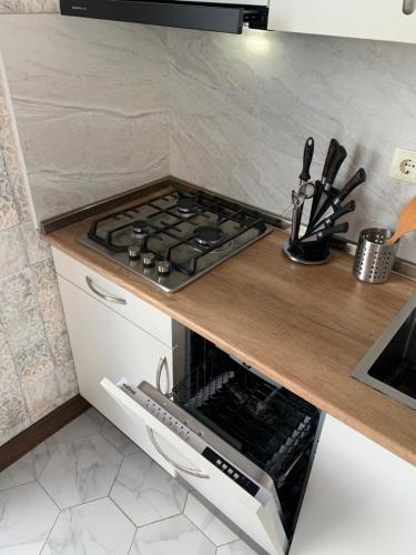 a kitchen with a stove and a counter top at Penthouse Sea Breeze in K'obulet'i