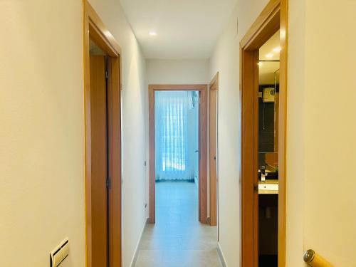 a hallway with a door leading into a room at Wind duplex Cambrils beach in Cambrils