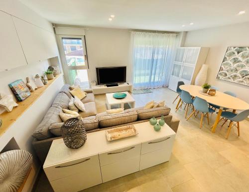 a living room with a couch and a table at Wind duplex Cambrils beach in Cambrils