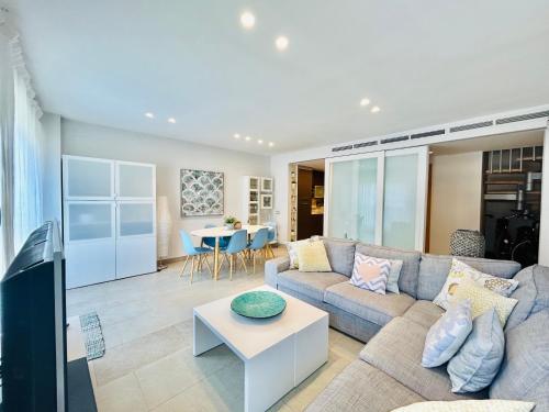 a living room with a couch and a table at Wind duplex Cambrils beach in Cambrils