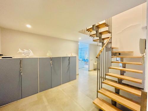 a spiral staircase in a house with a kitchen at Wind duplex Cambrils beach in Cambrils