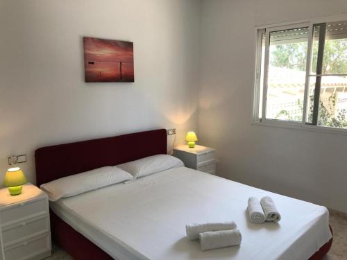 a bedroom with a bed with two towels on it at Residencial San Francisco in L'Eucaliptus