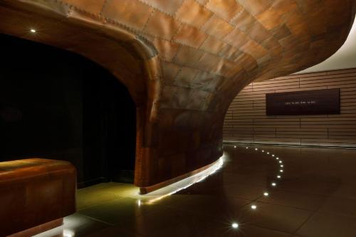 a dark room with an arch with lights on the floor at Sea Containers London in London
