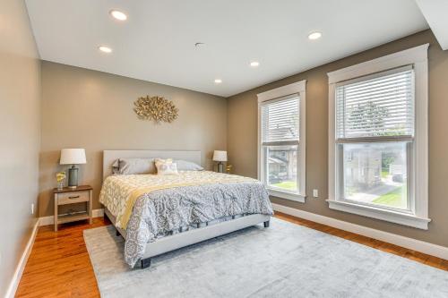 a bedroom with a bed and two windows at Pet-Friendly Lancaster Home 13 Mi to Dtwn Buffalo in Lancaster