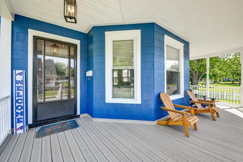 a blue house with two chairs on a porch at Pet-Friendly Lancaster Home 13 Mi to Dtwn Buffalo in Lancaster
