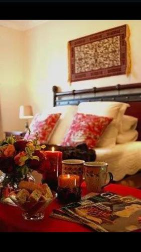 a bedroom with a bed and a table with food at Castelo Sutil Guest House in Bloemfontein