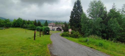 a road leading to a house in a field at Pension Panorama in Tanvald