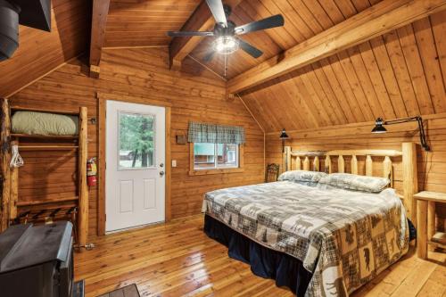 a bedroom with a bed and a ceiling fan at Lost Horse Lodge King Cabin 12 in Darby