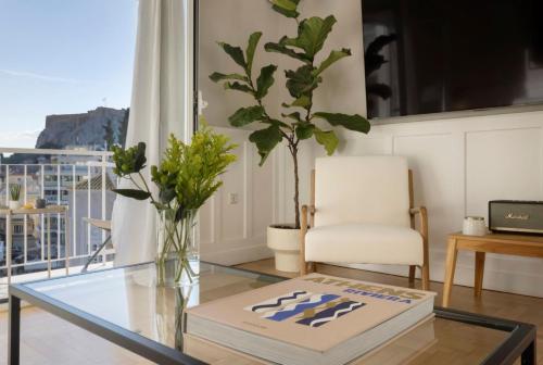 a living room with a glass table and a chair at Meliti Apartment in Plaka in Athens