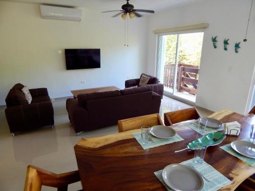 a living room with a table and a couch at 2 BR-house in Puerto Morelos with stunning view in Puerto Morelos