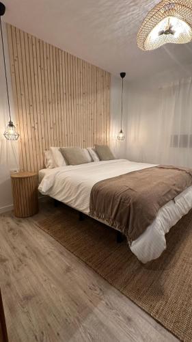 a bedroom with a large bed and two lights at Casa Regina Tenerife in Tamaimo