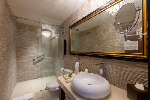 a bathroom with a white sink and a mirror at 1850 Hotel Boutique in Guanajuato