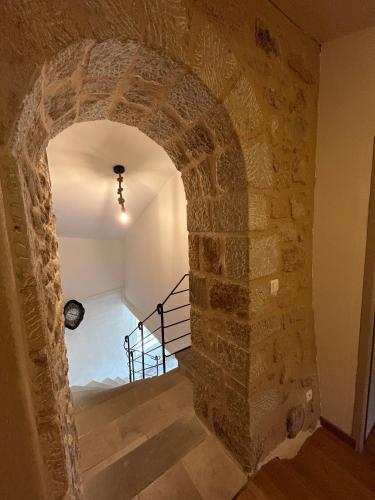 an archway leading to a staircase in a building at Mas Chantequinson in Les Assions