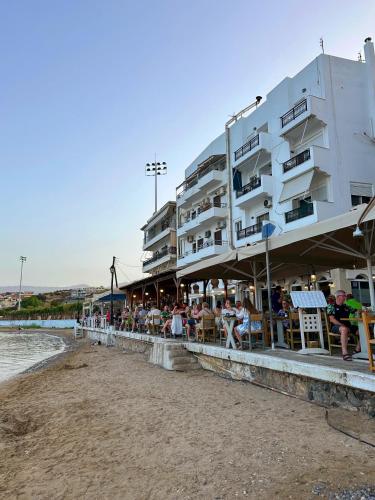 a group of people sitting outside of a building at FiloXenia by the Sea in Agios Nikolaos