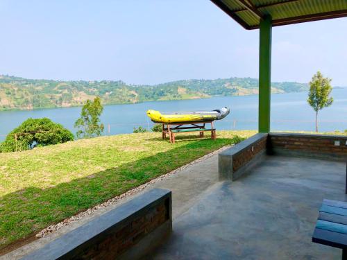 a table with a kayak on it next to a lake at Inzozi Eco Camp in Gishyita