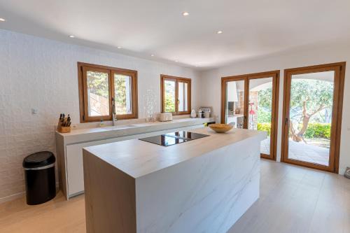 a kitchen with a large island in the middle at La Isla in Sa-Riera