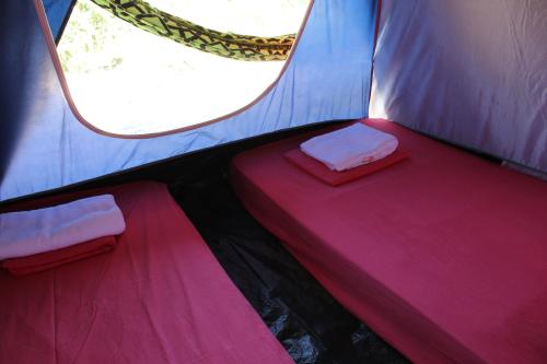 a room with two beds in a tent at Camping - Ecohospedagem Canto da da Coruja - traga seu equipamento de camping in Sao Jorge