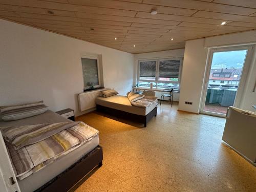 a bedroom with a bed and a couch in it at Monteuren und Studentenwohnungen Bettvermietung in Geislingen an der Steige