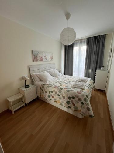 a bedroom with a bed and a wooden floor at Estrella de O Vicedo in O Vicedo