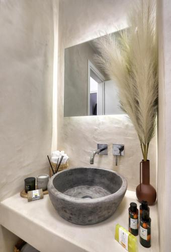 a bathroom sink with a large stone bowl at Lemoni House in Petras, Sitia, by Comfortbnb in Sitia