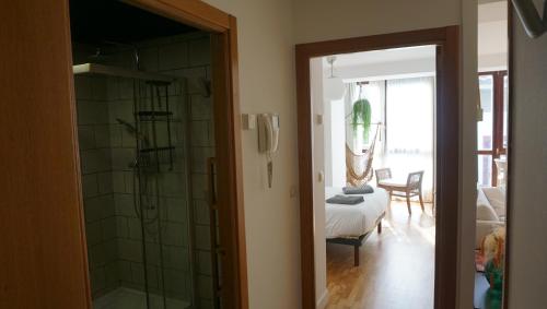 a bathroom with a shower and a bedroom at Arma Plaza by Basquelidays in Hondarribia