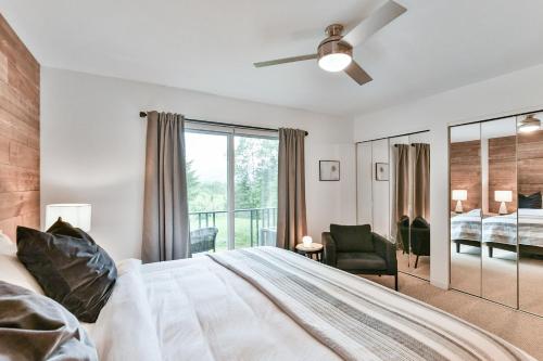 a bedroom with a bed and a window at Aiglon by Rendez-Vous Mont-Tremblant in Mont-Tremblant