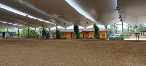 an empty arena with a building in the background at Hotel Campestre Ronda Ecuestre Rionegro in La Ceja