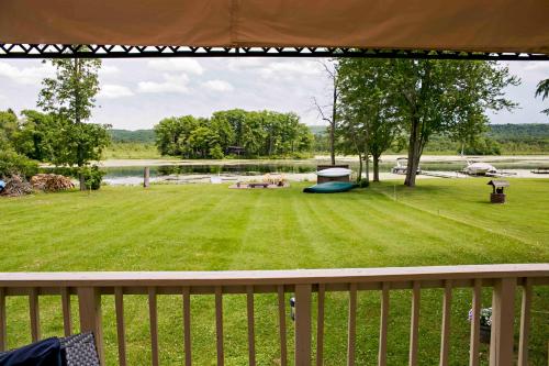 a view of a large yard from a deck at Serenity on Lamoka in Hammondsport
