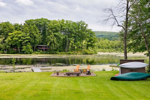 a backyard with a lake and a gazebo at Serenity on Lamoka in Hammondsport