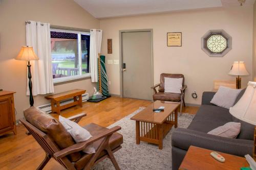 a living room with a couch and a table at Serenity on Lamoka in Hammondsport