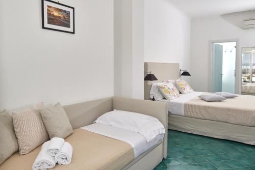a living room with two beds and a couch at Hotel Victoria Place in Anacapri