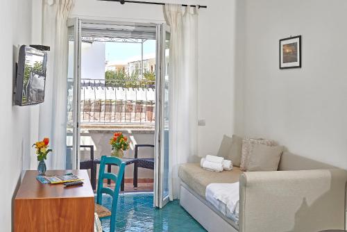 a living room with a couch and a table at Hotel Victoria Place in Anacapri