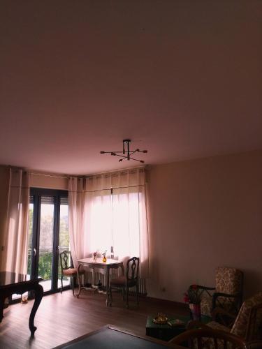 a living room with a table and a window at B&B Monte Bo Biella in Biella