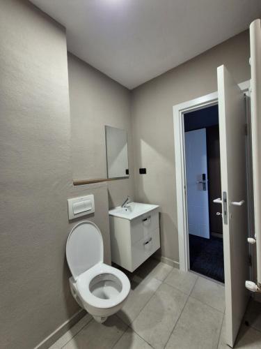 a bathroom with a toilet and a sink at SEAPOINT Boutique Hotel in Eforie Sud