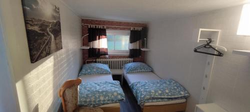 a small room with two beds and a window at Pension Panorama in Tanvald