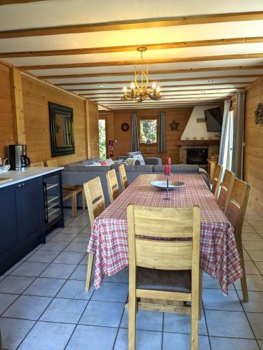 a kitchen and dining room with a table and chairs at Chalet Ruan Montriond - Mountain Voyages in Montriond