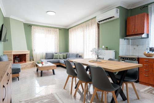 a kitchen and living room with a table and chairs at Sitholia Apartment Vatopedi in Vatopedi