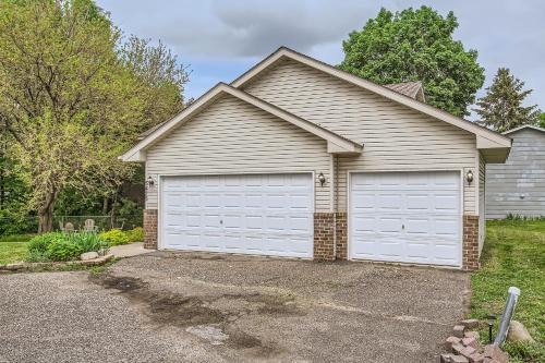 a house with two garage doors in a driveway at 4bd Central Location - Patio - Games in Ramsey