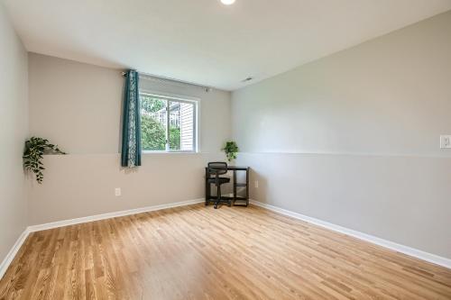 an empty room with a window and a wooden floor at 4bd Central Location - Patio - Games in Ramsey