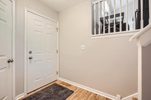a hallway with a white door and a stair case at 4bd Central Location - Patio - Games in Ramsey