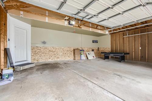 an empty room with a ping pong table in it at 4bd Central Location - Patio - Games in Ramsey