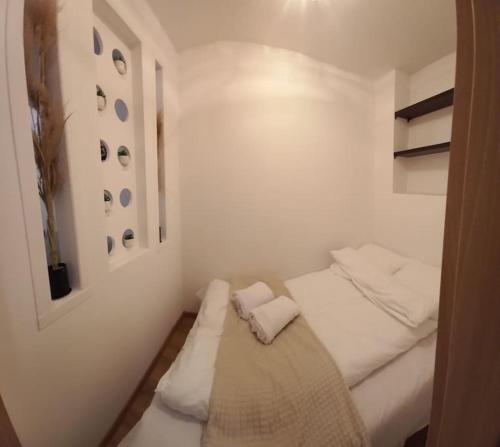 a small white room with a bed in it at Kawalerka w centrum in Wadowice