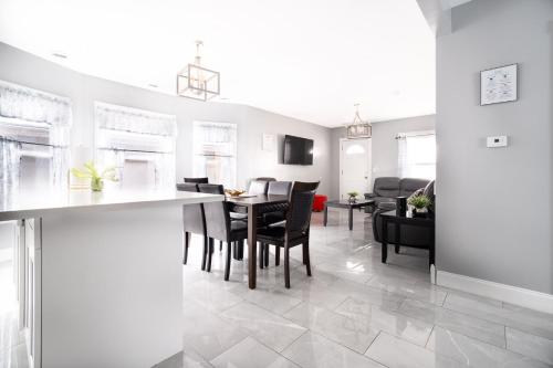 a kitchen and living room with a table and chairs at Comfy 4BR, 1 Bath Near the Falls & Casino in Niagara Falls